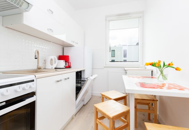 kitchen, kitchenette, dining area, dining table, chairs, kettle, stove, oven, dishwasher, fridge, coffee maker, toaster, cupboards, apartment, interio