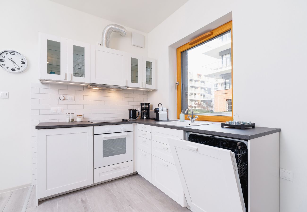 kitchen, kitchenette, kettle, toaster, electric hob, oven, fridge freezer, coffee machine, dishwasher, cupboards, dining area, apartment, interior, re