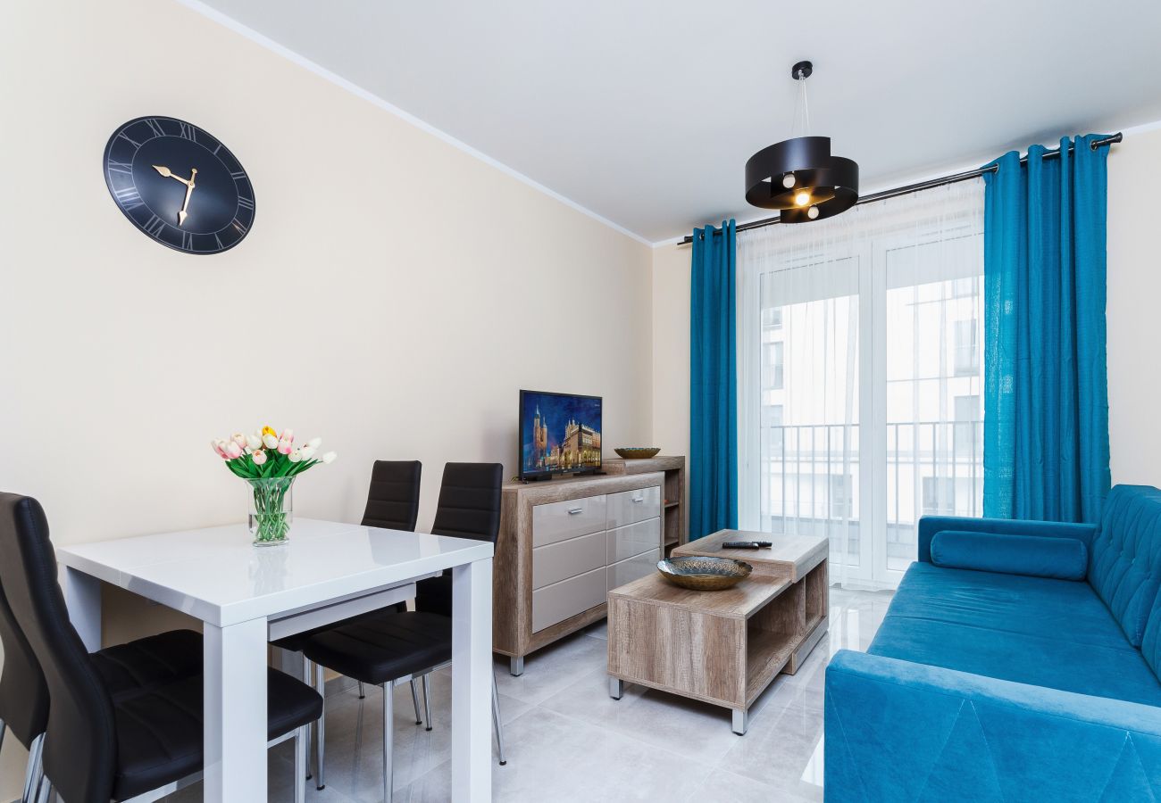 salon, sofa, stolik kawowy, telewizor, jadalnia, aneks kuchenny, apartament, wnętrze, wnętrze mieszkania, wynajem