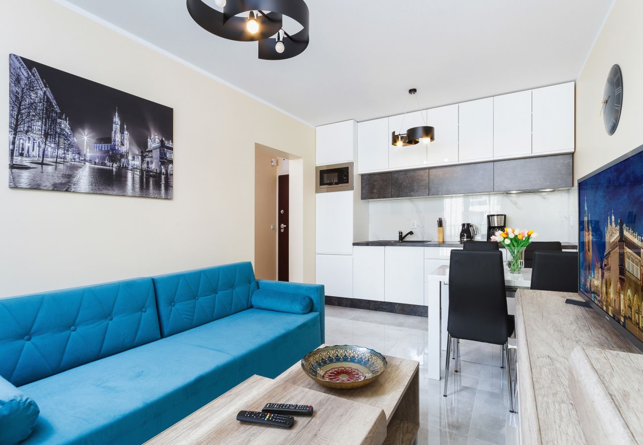 salon, sofa, stolik kawowy, telewizor, jadalnia, aneks kuchenny, apartament, wnętrze, wnętrze mieszkania, wynajem